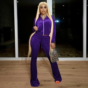 Detail of dark purple velvet tracksuit with cropped zip jacket and drawstring flare pants