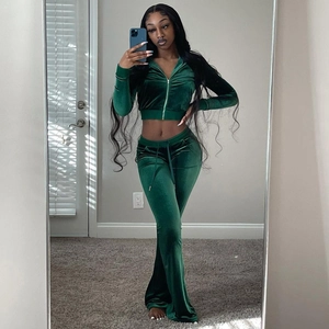 Macro detail of dark green velvet texture on cropped zip hoodie and flared pants set