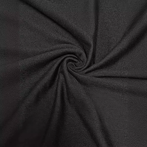 Elegant black knit maxi dress featuring a cinched waist and textured fabric spiral drape