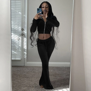 Detail view of women's black velvet two-piece set featuring slim fit flared pants and zip cardigan
