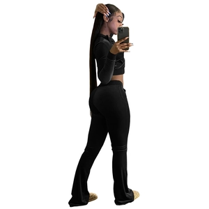 Detail view of smooth velvet fabric texture on black long sleeve cropped two-piece set