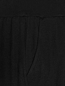 Detail of black yoga pants featuring a pleated waist design and functional side pocket