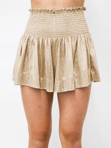 Detail of high-waisted champagne metallic pleated shorts with smocked elastic waistband