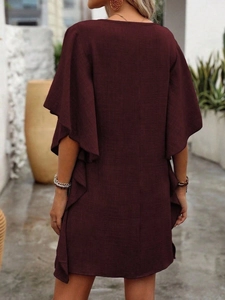 Detail of wine red cotton linen dress showing ruffle sleeves and fabric texture from behind