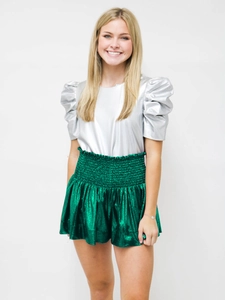 Close-up of metallic pleated fabric texture and elastic waistband of casual shorts