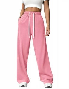 Detailed macro view of pink high-waist joggers with elastic waistband and white drawstrings