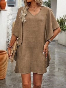 Detail of V-neck loose fit khaki dress showing natural linen fabric and batwing sleeve
