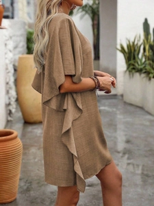 Detail of ruffle sleeve and textured linen fabric on a loose V-neck summer dress