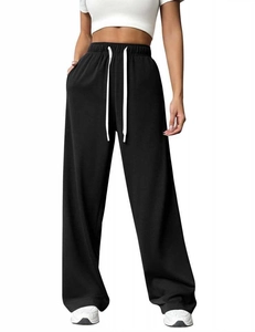Detail view of high-waist black wide-leg joggers with thick white drawstring and soft fabric