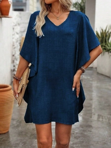 Detail of dark blue V-neck dress with butterfly sleeves and cotton linen texture
