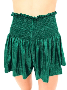 Detail of smocked elastic waistband with ruffles on shimmering green metallic shorts