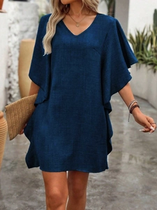 Close-up of V-neck and butterfly sleeve details on the navy blue linen texture dress