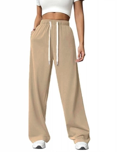 Detailed close-up of light khaki high-waisted wide-leg sweatpants with white drawstring