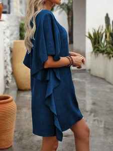 Detailed texture of navy ruffle dress in a Mediterranean courtyard setting