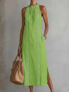 Detail view of the green halter maxi dress featuring elegant white lace embroidery accents