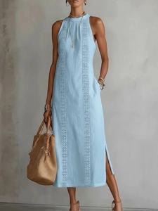 Detail of the light blue halter dress featuring vertical hollow lace embroidery and side slits