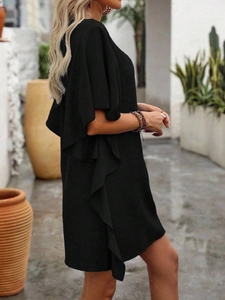 Detail of loose black summer dress featuring elegant ruffle sleeve and side trim texture