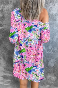 Detail of floral print pattern on pink long sleeve cardigan with vibrant blue and green motifs