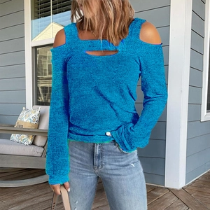 Detail of royal blue cold-shoulder knit top featuring chest cut-out design