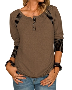 Close-up of brown Henley neck top with striped raglan sleeves and button detail