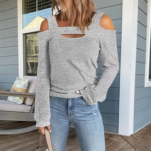 Detail of grey cold-shoulder knit top featuring front cutout and long sleeves