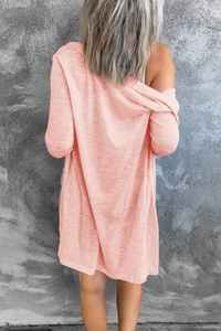 Close-up of pink long-sleeved cardigan showing the slub texture and lightweight knit fabric