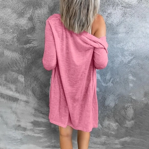 Detail of pink long-sleeve cardigan showing textured fabric and draped fit from back
