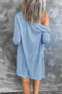 Detail view of the light blue knit cardigan back featuring a soft ribbed fabric texture