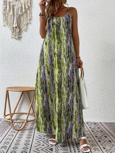 Green and purple abstract floral print maxi dress with spaghetti straps in a vacation setting