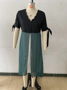 Detail of V-neckline with wavy edge and bow-knot sleeves on a two-piece patchwork dress