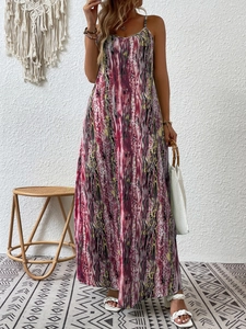 Detail of bohemian long dress with pink and yellow abstract prints in a rustic setting
