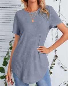 Detail of haze blue rib-knit T-shirt showing the elegant curved hemline on a model