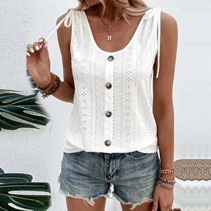 Detail of white sleeveless top with eyelet embroidery and stylish shoulder tie straps