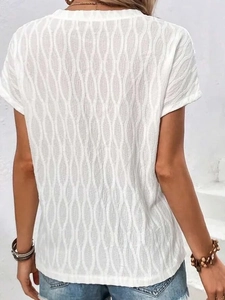 Detail view of white short-sleeved top with wave texture jacquard fabric and round neck