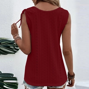 Macro detail of the dark red eyelet cutout fabric on woman's summer sleeveless top
