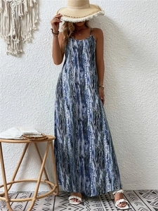 Detail of bohemian printed maxi dress with spaghetti straps and abstract patterns