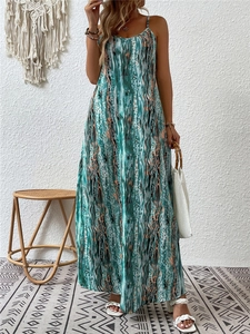 Bohemian maxi dress with abstract teal print styled with woven bag and sandals