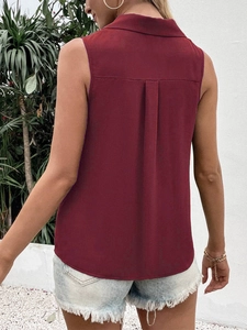 Detail view of wine red sleeveless shirt featuring a back box pleat for a relaxed fit