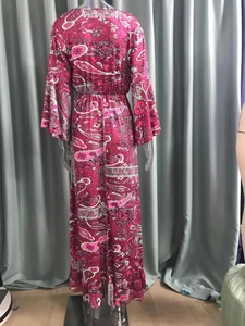 Detailed back view of a magenta paisley print maxi dress with bell sleeves and high waist