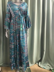 Detail view of Bohemian floral dress showing flared sleeves and tasseled drawstring waist