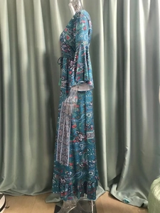 Detail of bohemian floral print dress with bell sleeves and drawstring tassel waist