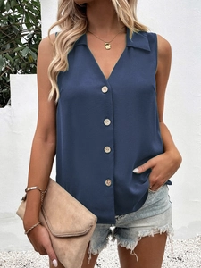 Detail of deep blue sleeveless chiffon top with V-neckline and four round buttons