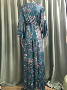 Back view of bohemian floral maxi dress featuring paisley print and flared sleeves