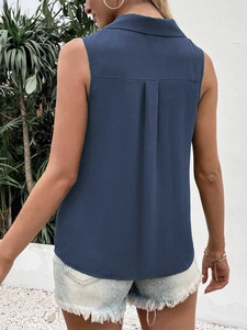 Detail of navy blue sleeveless chiffon shirt showing back pleat and curved hem