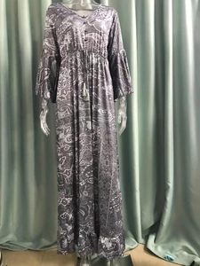 Detail of bohemian floral print dress with paisley patterns, V-neck, and tassel drawstrings