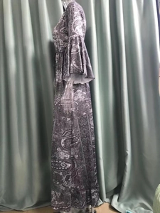 Detail of bohemian floral maxi dress with paisley print and layered bell sleeves