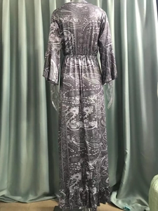Detail view of the back of a bohemian paisley print maxi dress with elastic waist and ruffles