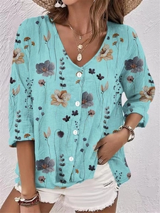 Detailed close-up of light blue floral V-neck chiffon blouse with elegant white buttons