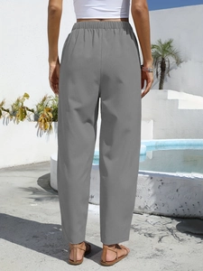 Rear view of grey linen blend loose casual high waist trousers for women in resort style