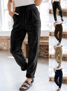 Detailed view of women's corduroy trousers with elastic waist and ribbed fabric texture